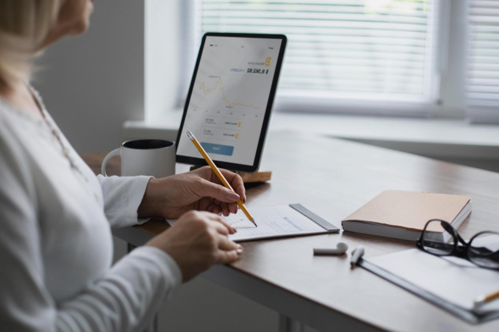 Modern collaborative workspace with students working together on financial projects